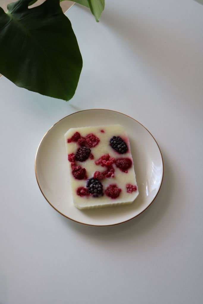 Frozen Greek yogurt berry bark with raspberries and blackberries on a white plate